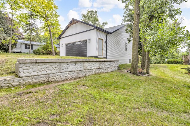 10781 Woodbrook Dr, Cement City, MI 49233 - view of home's exterior with a garage and a lawn
