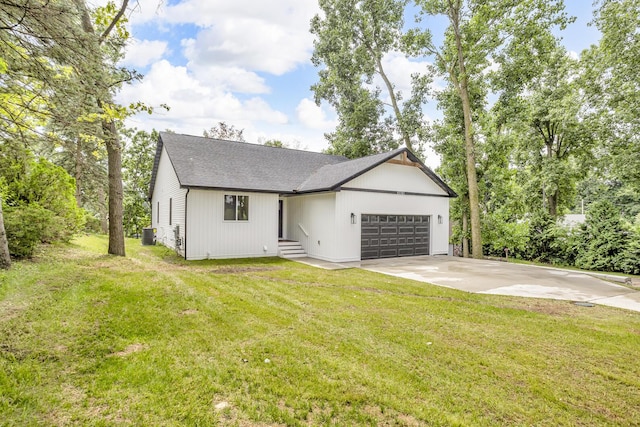 10781 Woodbrook Dr, Cement City, MI 49233 - modern farmhouse with a garage, concrete driveway, a front lawn, and roof with shingles