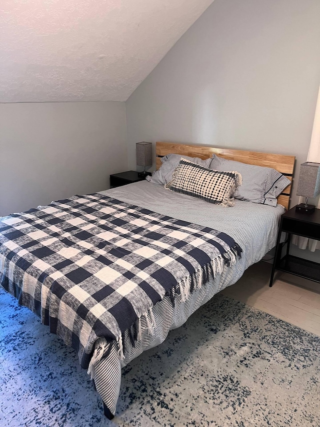 bedroom featuring vaulted ceiling