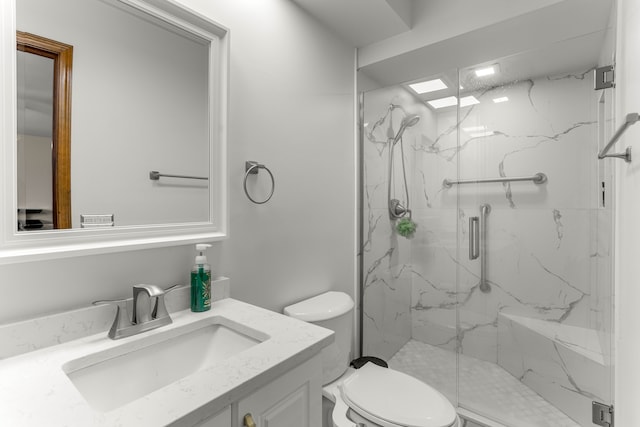 bathroom featuring an enclosed shower, vanity, and toilet