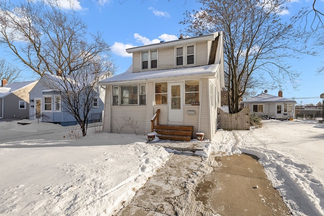 view of front of property featuring entry steps and fence