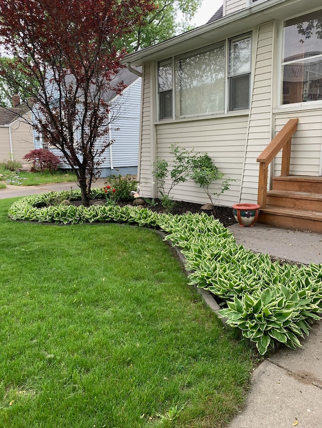 view of property exterior with a yard