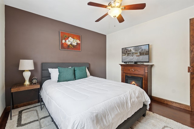 bedroom with ceiling fan and wood-type flooring