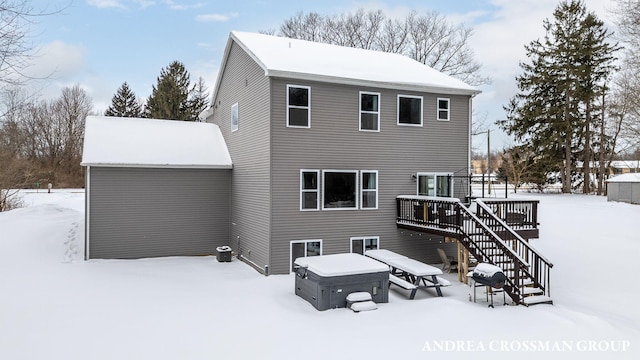 snow covered house with a deck