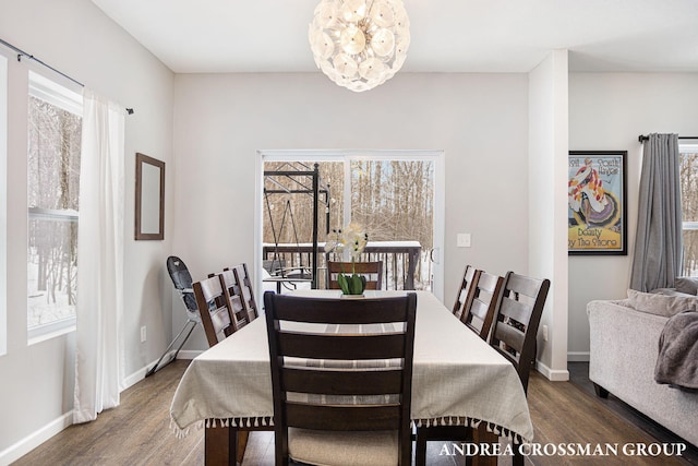 dining area featuring a notable chandelier, plenty of natural light, and dark hardwood / wood-style floors