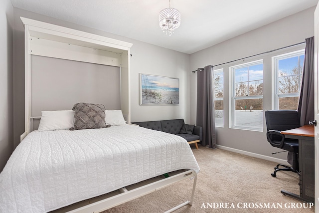 carpeted bedroom featuring a notable chandelier