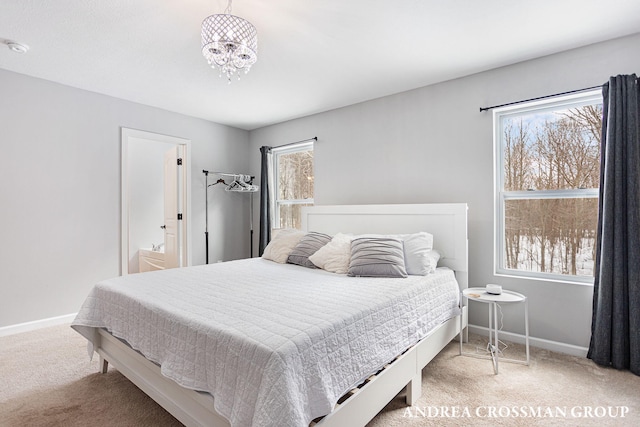 bedroom with carpet and an inviting chandelier