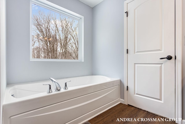 bathroom featuring a tub to relax in and hardwood / wood-style flooring