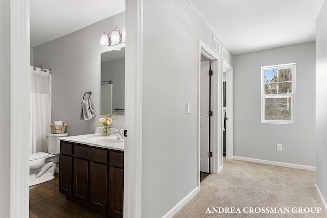 bathroom featuring vanity and toilet