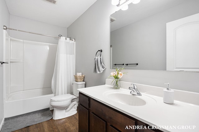 full bathroom with shower / tub combo, vanity, hardwood / wood-style floors, and toilet