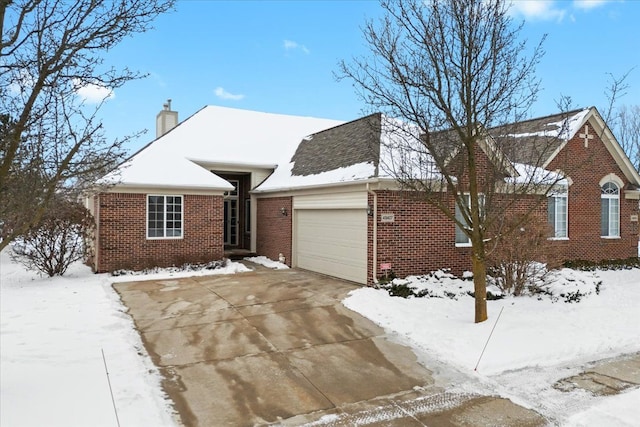 single story home featuring a garage, driveway, brick siding, and a chimney