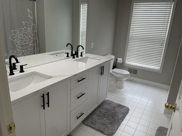 bathroom featuring vanity, toilet, and tile patterned floors