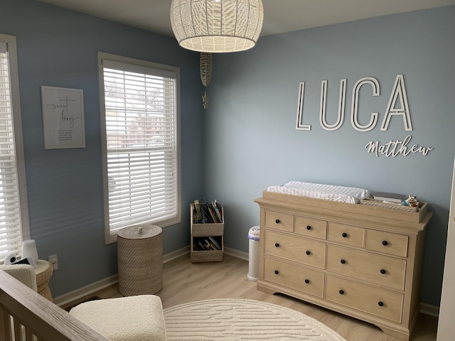 bedroom featuring light wood-type flooring and multiple windows