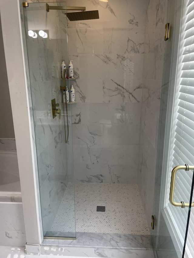 bathroom featuring a shower with shower door