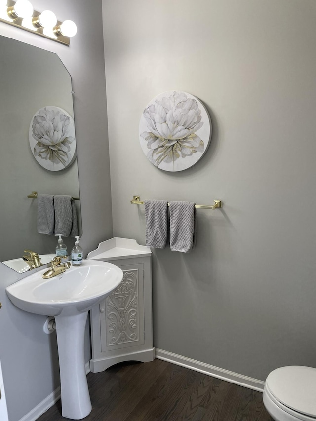 bathroom featuring toilet and wood-type flooring