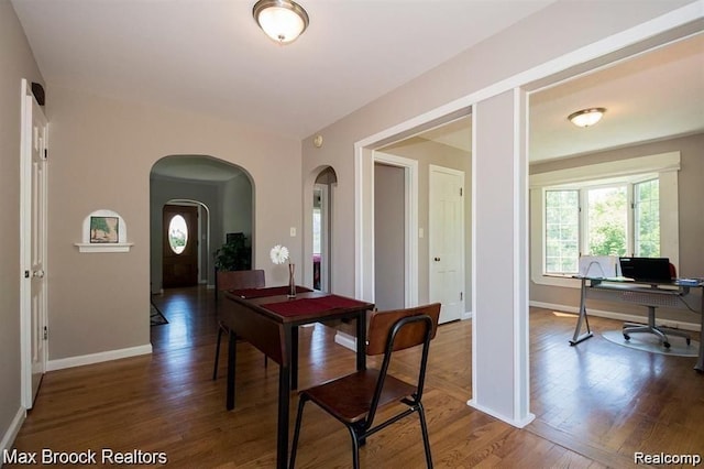 dining space featuring dark hardwood / wood-style floors and a healthy amount of sunlight