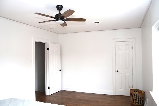 unfurnished bedroom featuring ceiling fan, visible vents, and dark wood-style flooring