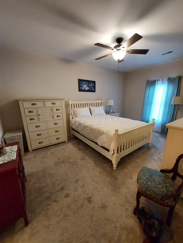 carpeted bedroom with ceiling fan and visible vents