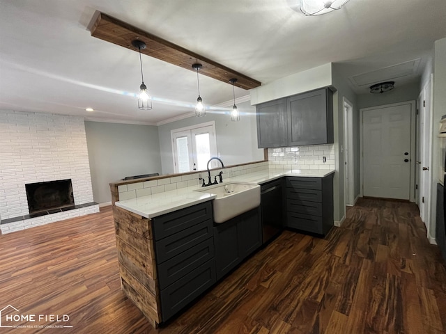 kitchen featuring dishwasher, dark hardwood / wood-style flooring, gray cabinets, sink, and kitchen peninsula