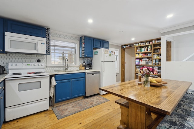 kitchen featuring white appliances, light hardwood / wood-style floors, blue cabinets, and sink