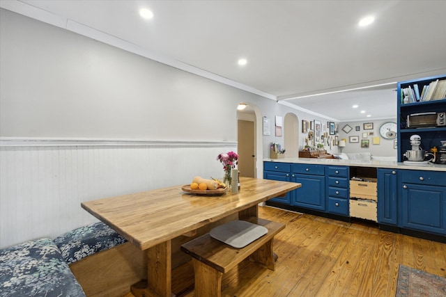 kitchen featuring ornamental molding, blue cabinets, and light hardwood / wood-style flooring