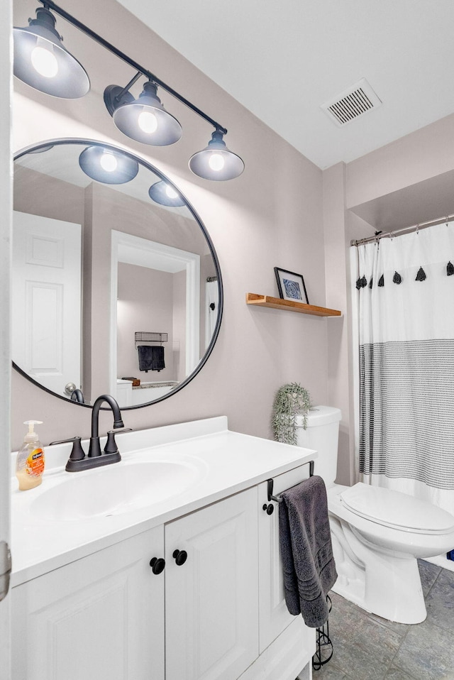 bathroom with toilet and vanity