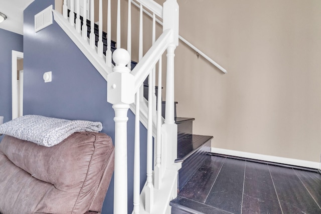 stairs featuring hardwood / wood-style flooring