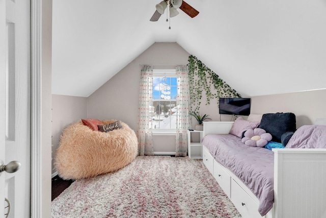 carpeted bedroom with vaulted ceiling and ceiling fan