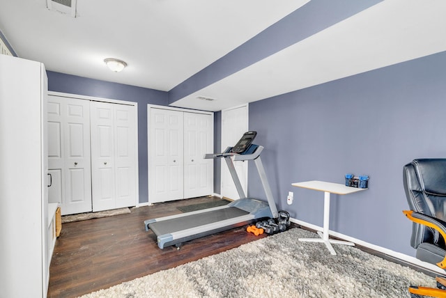 exercise room featuring dark hardwood / wood-style floors