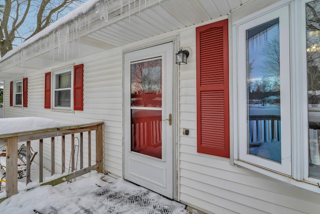 view of snow covered property entrance