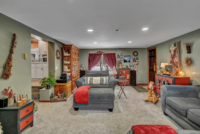 living room with recessed lighting, light colored carpet, and baseboards