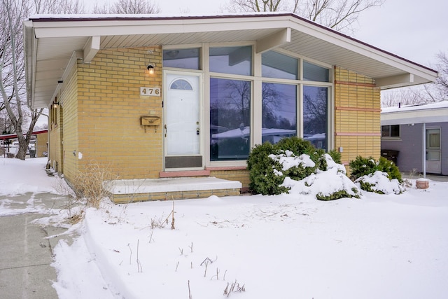 view of snow covered property entrance