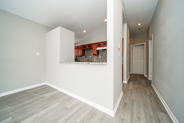 hallway with light hardwood / wood-style flooring