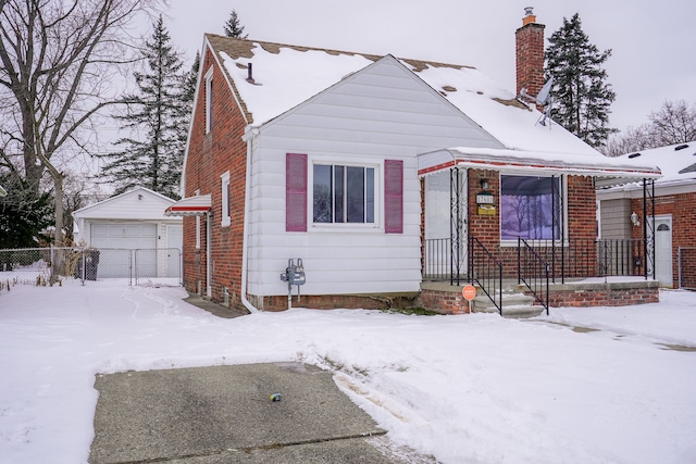 bungalow-style house with a garage and an outbuilding