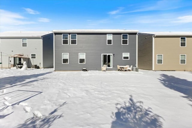 view of snow covered back of property