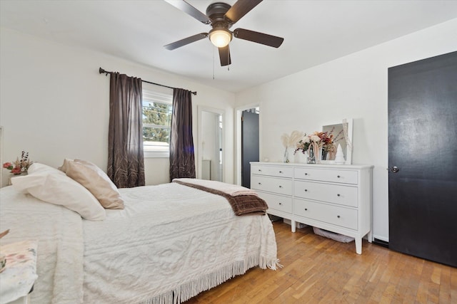 bedroom with light wood-type flooring and ceiling fan