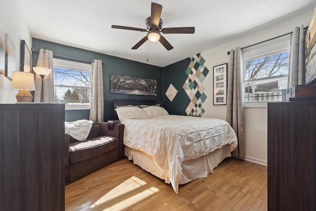 bedroom with ceiling fan and light hardwood / wood-style flooring