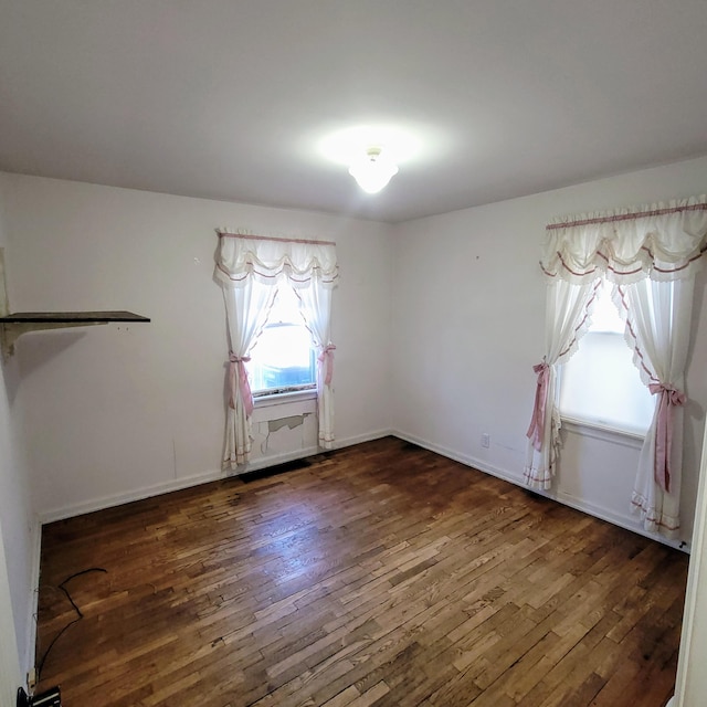 empty room with dark hardwood / wood-style floors