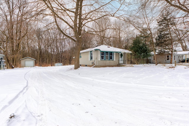 view of front of house featuring a garage and an outdoor structure