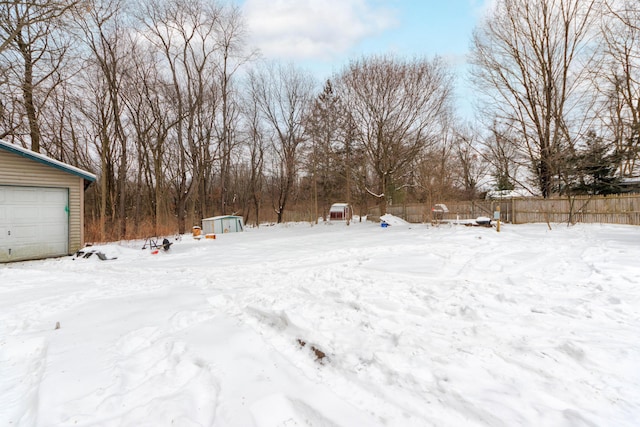 yard covered in snow featuring an outdoor structure