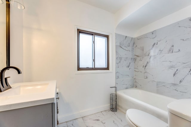 bathroom featuring toilet, a bathtub, and vanity