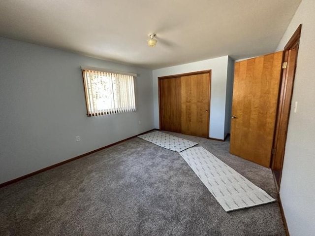 unfurnished bedroom featuring a closet and dark colored carpet