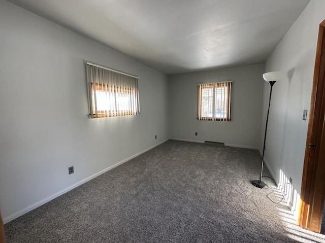 unfurnished bedroom with dark carpet