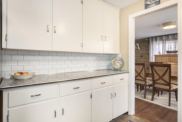 kitchen with white cabinets, dark hardwood / wood-style floors, and decorative backsplash