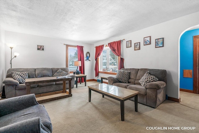 living room featuring a textured ceiling and light colored carpet