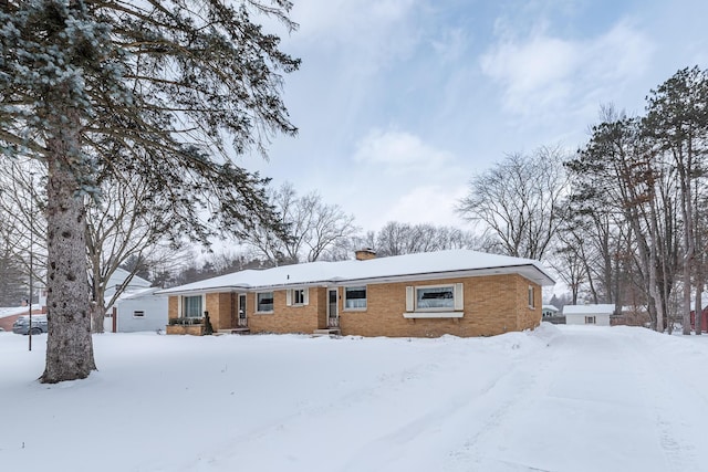 view of snow covered back of property