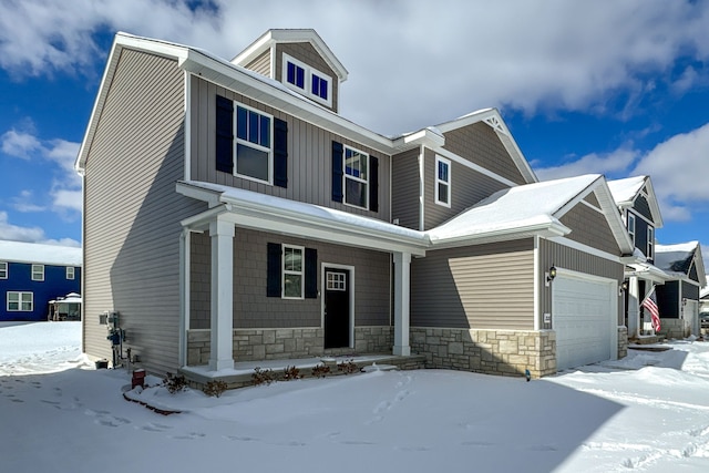 view of front facade featuring a garage, stone siding, and board and batten siding