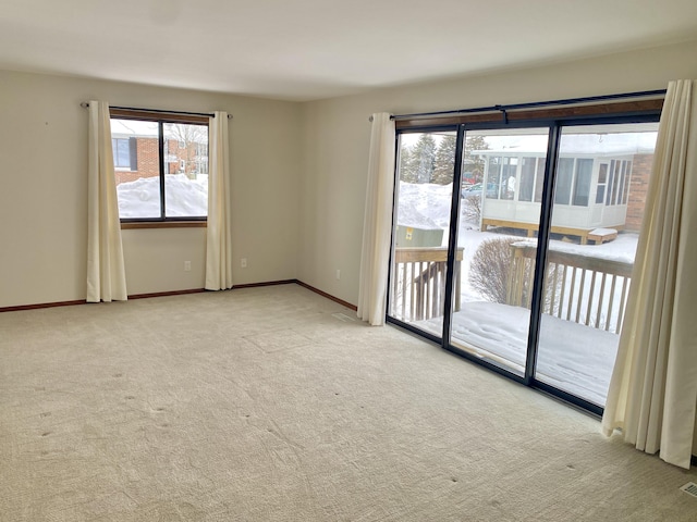 unfurnished room with light carpet, baseboards, and visible vents