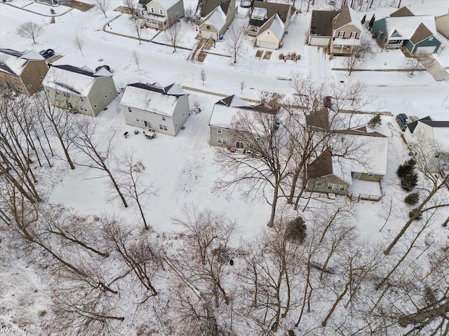 snowy aerial view with a residential view