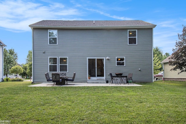 rear view of house featuring a patio and a lawn